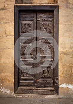 Wooden aged grunge door and stone bricks wall