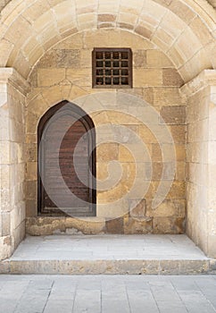 Wooden aged vaulted ornate in a recessed stone wall