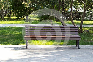 Wooden alone bench in the park against .