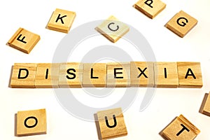 Wooden alphabet blocks with DYSLEXIA word in the center on white background