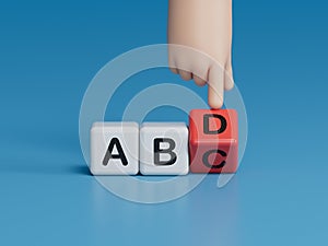 Wooden alphabet cube with words ABCD closeup and children hands on black background. Selective focus and education concept.