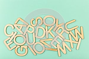 Wooden alphabet letters on blue paper background