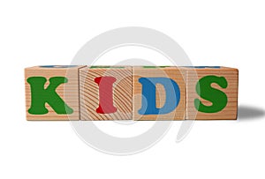 Wooden alphabet toy blocks with the text: Kids.  kids ABC cubes on white background with copy space