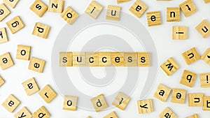 Wooden alphabet words `success` on white background.