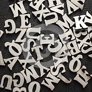 Wooden alphabets on a dark woode background
