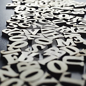 Wooden alphabets on a dark woode background