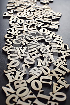 Wooden alphabets on a dark woode background