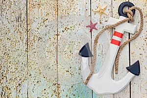 Wooden anchor on the decorative background