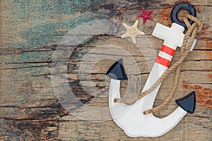 Wooden anchor on the decorative background