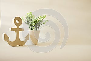 Wooden anchor decorative with small tree in pot vintage style background