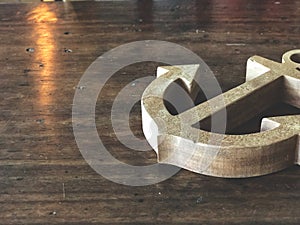 Wooden anchor on the vintage wooden table with natural light.