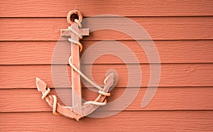 Wooden anchor on wall background