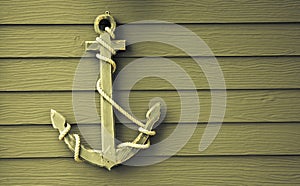 Wooden anchor on wall background