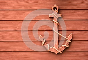 Wooden anchor on wall background