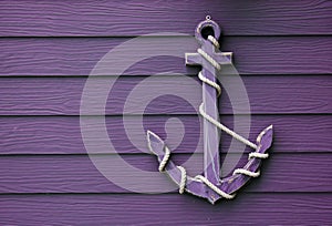 Wooden anchor on wall background