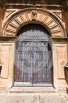 Wooden ancient door of Church San Mateo in Banos de la Encina photo