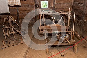 Wooden antique loom in a wooden house