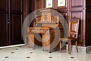 wooden antique secretaire or bureau in a house - retro furniture interior