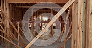 Wooden apartment building under construction in new developing suburban area. Development of residential housing in