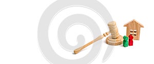 Wooden apartment house with keys and a judge hammer on a white background. The concept of the trial of an apartment house. Confisc