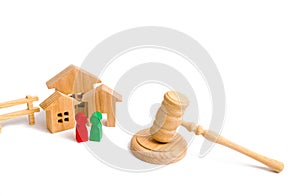 Wooden apartment house with people, keys and a judge hammer on a white background. The concept of laws and regulations for tenants