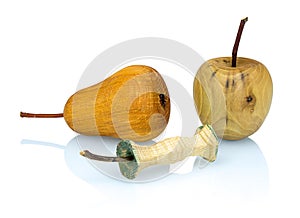 Wooden apple, apple stub and pear made from a different types of wood isolated on white background with shadow reflection.