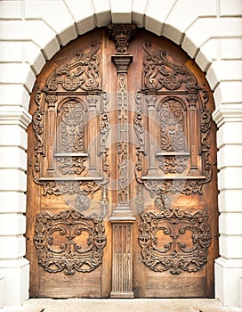 Wooden arc decorated door on exterior wall