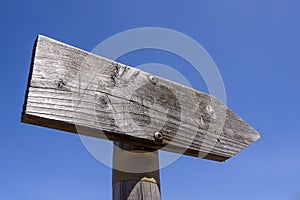 Wooden arrow sign post or road signpost