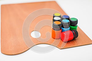 Wooden art palette with paint isolated on white background with copyspace