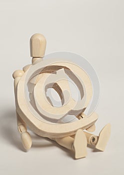 Wooden artist mannequin holding wooden email sign