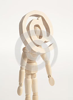 Wooden artist mannequin and wooden email sign instead of head.