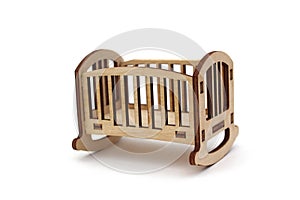 Wooden baby toy bed assembled from plywood on a white isolated background.