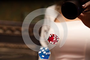 Wooden backgammon and girl`s hands with bones