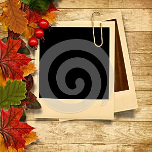 Wooden background with autumn leaves and frame for photo