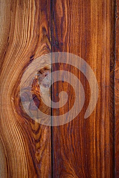 Wooden background, close-up. Brown vertical boards. Facing the exterior walls of the house. Ramshackle wall with peeling paint