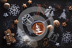 Wooden background with cup of hot coffee and gift wrapping of Christmas cookies