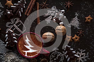 Wooden background with cup of hot coffee and gift wrapping of Christmas cookies