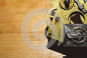 Wooden background with detail of clock mechanism. gears of a mechanical watch