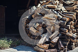 Wooden background. Firewood for the winter, stacks of firewood, pile of firewood.