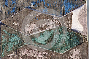 Wooden background in the form of rhombs with peeling paint