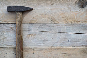 Wooden background with a hammer, home improvement concept