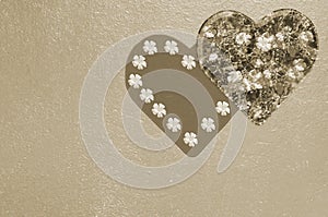 Wooden background with hearts and flowers tinted with sepia