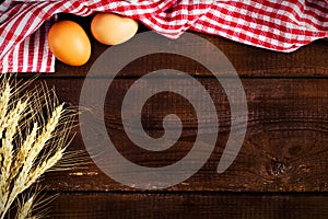 Wooden background, kitchen towel and cooking ingredients