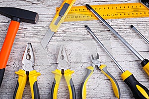 On a wooden background the layout of various construction tools. Top view.