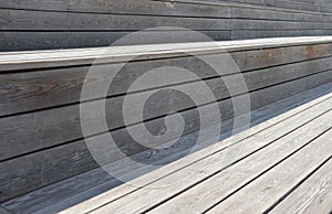 Wooden background of light and dark horizontal stripes of brown planks, slats