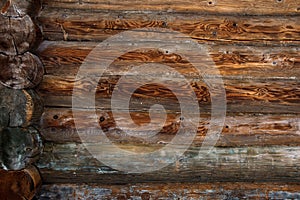 Wooden background. Log house wall background. Old weathered orange logs