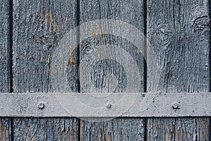 Wooden background made of vertical planks with blue gray peeled grunge surface and metal horizontal plank