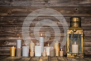 Wooden background in with many burning candles and a old rustic