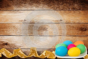 Wooden background with multicolored eggs