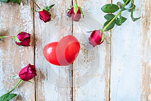 Wooden background with red roses and hearts Valentine`s Day concept